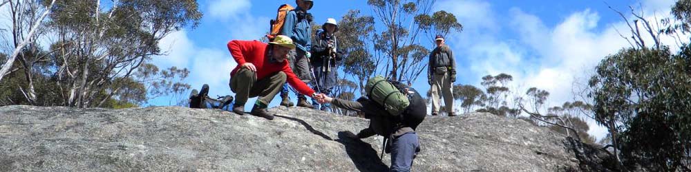 Bushwalkers demonstrate fitness ascending a rockface