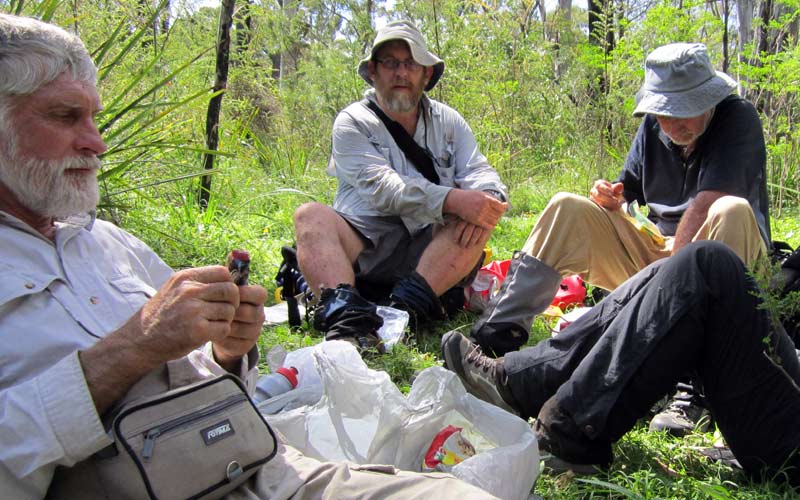 Bushwalking club members safely enjoy the social aspects of a bushwalk